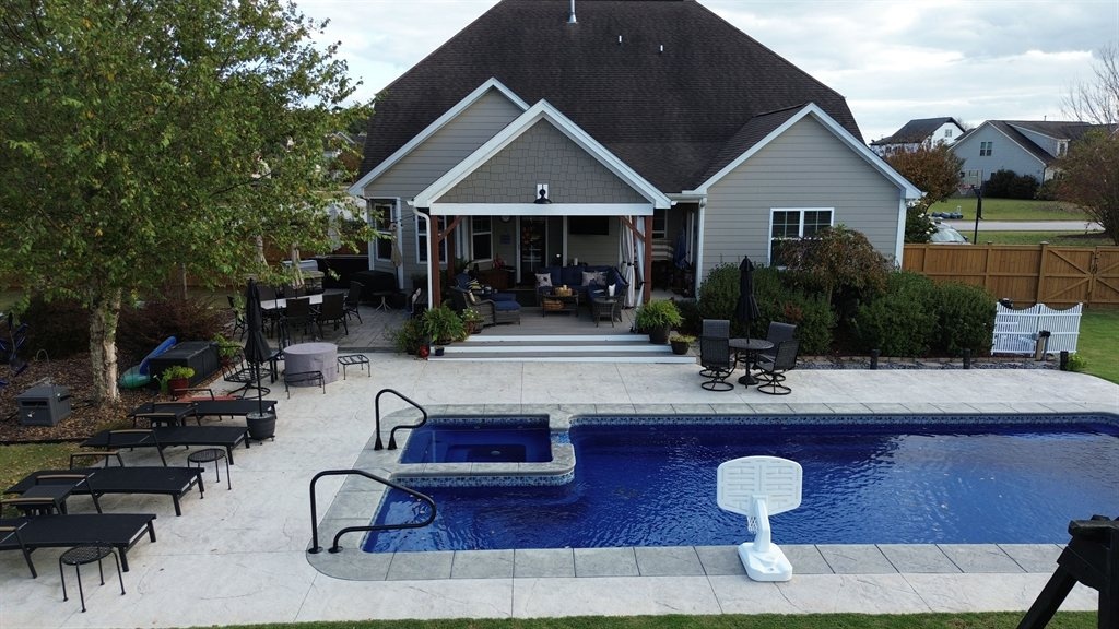 Beautiful outdoor living space with pool and patio by Conway Construction Management